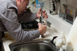 Plumber dealing with kitchen plumbing issue in Turlock